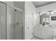 Elegant bathroom featuring a glass shower, double sinks, white cabinets, and bright lighting at 78 Crumley Se St, Atlanta, GA 30312