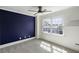 Modern bedroom with navy accent wall, plush carpet, and a window providing natural light at 78 Crumley Se St, Atlanta, GA 30312