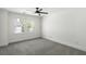 This bedroom offers neutral carpet, a ceiling fan, a window for natural light, and white trim at 78 Crumley Se St, Atlanta, GA 30312