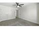 Bedroom featuring neutral carpet, a ceiling fan, and double door closets at 78 Crumley Se St, Atlanta, GA 30312