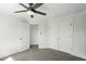 Bright bedroom with neutral walls, gray carpet, ample closet space, and two doors at 78 Crumley Se St, Atlanta, GA 30312