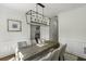 Formal dining room boasts wainscoting, a modern chandelier, and a glimpse into the living space at 78 Crumley Se St, Atlanta, GA 30312