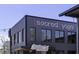 Sacred Yoga studio with a modern gray exterior, large windows, and a welcoming Junior's sign at 78 Crumley Se St, Atlanta, GA 30312