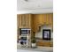 Close-up of the kitchen area featuring built-in stainless steel appliances and plentiful wooden cabinets at 78 Crumley Se St, Atlanta, GA 30312