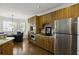 Bright kitchen featuring wood cabinets, stainless steel appliances, and a connected dining area at 78 Crumley Se St, Atlanta, GA 30312