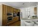 Spacious eat-in kitchen with stainless steel appliances, wooden cabinetry, and breakfast bar seating at 78 Crumley Se St, Atlanta, GA 30312