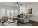 Open living room boasts hardwood floors, neutral tones, ceiling fan, and access to an outdoor balcony at 78 Crumley Se St, Atlanta, GA 30312