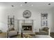 Inviting living room with hardwood floors, a cozy fireplace, neutral furniture, a ceiling fan, and ample natural light at 78 Crumley Se St, Atlanta, GA 30312