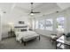 This bedroom features large windows, a ceiling fan, tray ceiling, and neutral tones at 78 Crumley Se St, Atlanta, GA 30312