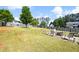 Expansive backyard showcasing lush lawn, mature trees, fenced perimeter, and a cozy firepit area at 102 Autumn Brooke Trl, Dallas, GA 30157