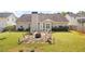 Spacious backyard featuring a firepit area, manicured landscaping, and the home's exterior at 102 Autumn Brooke Trl, Dallas, GA 30157