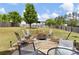 Private backyard with patio and firepit area surrounded by comfortable seating and mature trees at 102 Autumn Brooke Trl, Dallas, GA 30157
