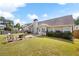 Backyard featuring lush lawn, patio with firepit, manicured landscaping, and the home's exterior at 102 Autumn Brooke Trl, Dallas, GA 30157
