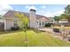 Well-maintained backyard with lush green lawn, patio with firepit, and manicured landscaping at 102 Autumn Brooke Trl, Dallas, GA 30157