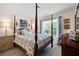 Comfortable bedroom with a four-poster bed, wooden floors, and window with blinds at 102 Autumn Brooke Trl, Dallas, GA 30157