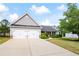 Home exterior featuring a two-car garage, manicured landscaping, and a well-maintained front lawn at 102 Autumn Brooke Trl, Dallas, GA 30157