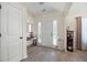 Bright foyer with hardwood floors, a white front door, and stylish decorative accents at 102 Autumn Brooke Trl, Dallas, GA 30157