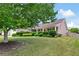 Charming home with manicured front yard, mature trees, lush shrubs, and well-maintained lawn at 102 Autumn Brooke Trl, Dallas, GA 30157