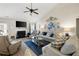 Cozy living room with a fireplace, plush sofas, and a ceiling fan for added comfort at 102 Autumn Brooke Trl, Dallas, GA 30157