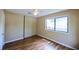 This bedroom features hardwood floors, a window, and a closet with sliding doors at 1606 Parkaire Xing # 1606, Marietta, GA 30068