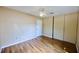 This bedroom features hardwood floors, a ceiling fan, and a closet with sliding doors at 1606 Parkaire Xing # 1606, Marietta, GA 30068
