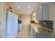 Well-lit kitchen featuring granite countertops and modern appliances at 1606 Parkaire Xing # 1606, Marietta, GA 30068