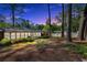Large backyard with mature trees viewed at dusk at 561 Sybil Se Ln, Marietta, GA 30067