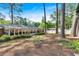 Spacious backyard with mature trees and a view of the home's exterior at 561 Sybil Se Ln, Marietta, GA 30067