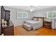 Comfortable bedroom featuring a ceiling fan, hardwood floors, and bright natural light at 561 Sybil Se Ln, Marietta, GA 30067