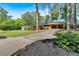 Charming brick home with lush landscaping, a covered carport, and long driveway set on a well-manicured lawn at 561 Sybil Se Ln, Marietta, GA 30067