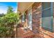 Charming brick home with lush landscaping and a covered entrance, with a brick porch leading to the front door at 561 Sybil Se Ln, Marietta, GA 30067