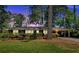 Charming brick home with lush landscaping and a covered carport, beautifully captured at twilight at 561 Sybil Se Ln, Marietta, GA 30067