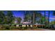 Charming brick home with lush landscaping and a covered carport, beautifully captured at twilight at 561 Sybil Se Ln, Marietta, GA 30067