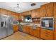 Classic kitchen with wood cabinets, stainless steel refrigerator, and hardwood floors at 561 Sybil Se Ln, Marietta, GA 30067