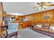 Charming living area with wood-paneled walls and an adjacent kitchen for easy entertaining at 561 Sybil Se Ln, Marietta, GA 30067