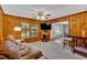 Warm and inviting living room with wood-paneled walls and a modern entertainment center at 561 Sybil Se Ln, Marietta, GA 30067