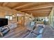 Spacious sunroom featuring wood-beam ceilings, brick accent wall, and sliding glass windows at 561 Sybil Se Ln, Marietta, GA 30067