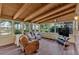 Relaxing sunroom with vaulted wood ceiling, lots of windows, and comfortable seating at 561 Sybil Se Ln, Marietta, GA 30067