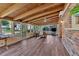 Bright sunroom with wood-beam ceilings, hardwood flooring, and expansive window views at 561 Sybil Se Ln, Marietta, GA 30067