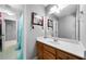 Cozy bathroom with warm wood vanity and a mirror at 7401 Cherry Blossom Way, Winston, GA 30187