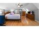 Spacious bedroom with hardwood floors, complemented by a ceiling fan and natural light at 7401 Cherry Blossom Way, Winston, GA 30187