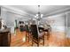 Open dining area with hardwood floors flowing into the living room, perfect for entertaining at 7401 Cherry Blossom Way, Winston, GA 30187