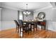 Comfortable dining area featuring hardwood floors and an elegant light fixture at 7401 Cherry Blossom Way, Winston, GA 30187