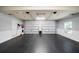 Large two-car garage with epoxy floors and white wainscoting at 7401 Cherry Blossom Way, Winston, GA 30187
