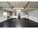 Spacious garage with rubber flooring, wainscotting, and organized storage for various needs at 7401 Cherry Blossom Way, Winston, GA 30187