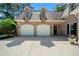 Spacious garage with two doors and ample parking in front of the brick home at 7401 Cherry Blossom Way, Winston, GA 30187