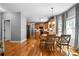 Open concept kitchen with wooden cabinetry, hardwood floors, and an adjacent dining area at 7401 Cherry Blossom Way, Winston, GA 30187