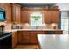 Well-equipped kitchen featuring custom wood cabinets, stone countertops, and stainless-steel appliances at 7401 Cherry Blossom Way, Winston, GA 30187