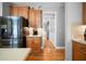 Gourmet kitchen with stainless steel appliances, hardwood floors, and wood cabinets at 7401 Cherry Blossom Way, Winston, GA 30187