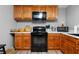 Functional kitchen featuring modern appliances, wood cabinets, and counter space for cooking at 7401 Cherry Blossom Way, Winston, GA 30187
